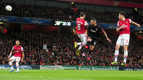 Olympiakos' Kostas Mitroglou scores the equaliser against Arsenal