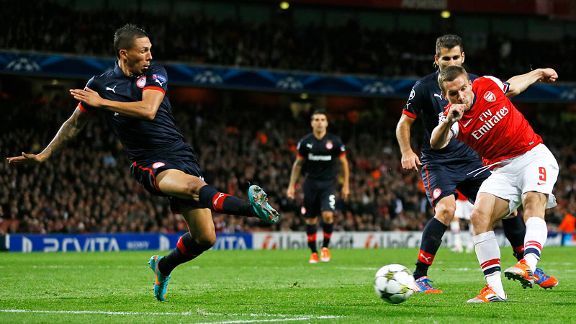 Arsenal's Lukas Podolski, right, scores his sides second goal