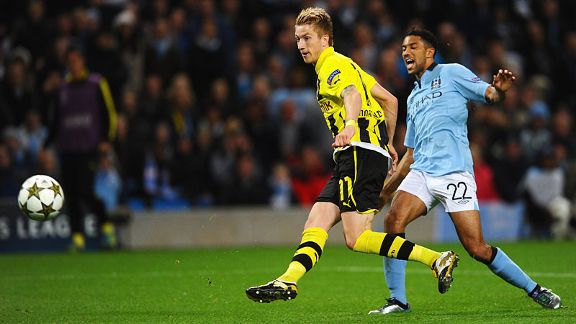 Marco Reus of Borussia Dortmund scores against Man City
