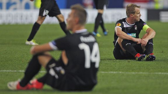 Viktoria Plzen's Radim Reznik and David Limbersky show their disappointment after their late defeat to Atletico Madrid