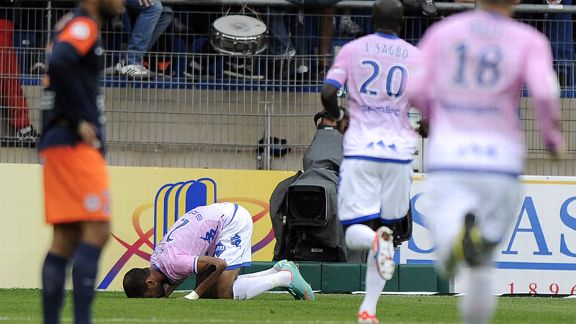 Evian's hat-trick Saber Khelifa prays after scoring against Montpellier