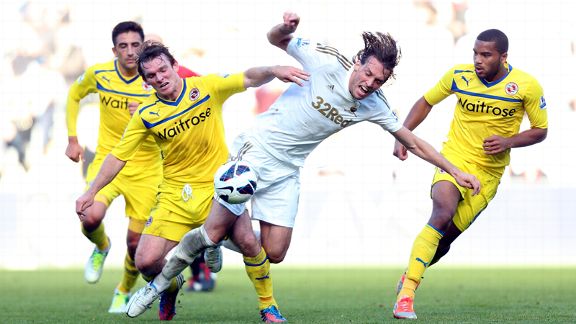Reading's Jay Tabb tackles Swansea's Michu