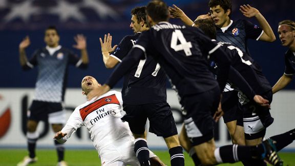 Dinamo Zagreb players protest their innocence as PSG's Jeremy Menez claims a foul