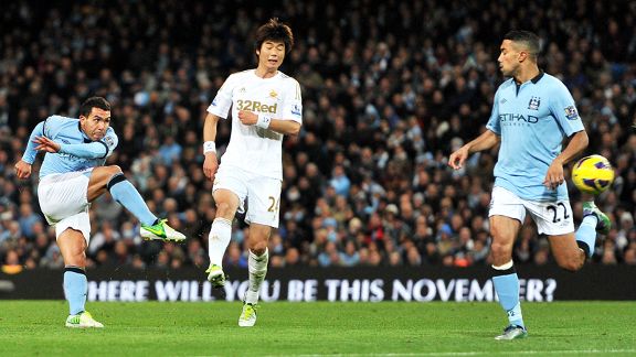 Carlos Tevez scores his fine winner against Swansea