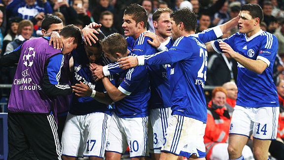 Jefferson Farfan is mobbed after scoring the goal which earned Schalke a 2-2 draw with Arsenal