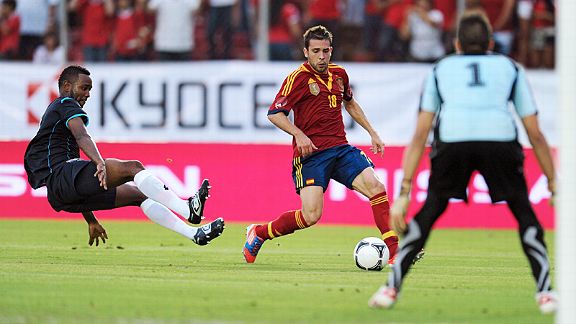 Felipe Baloy leaves the ground to make a tackle on Jordi Alba 