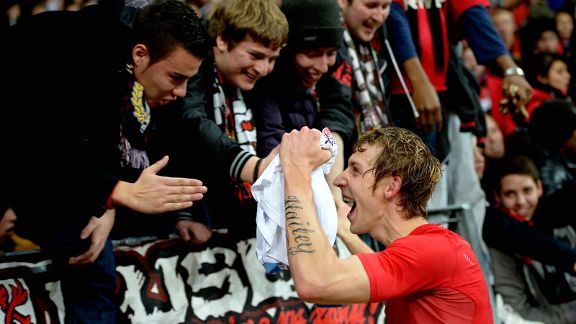 Leverkusen's Stefan Kiessling celebrates with fans after opening the scoring against Schalke 