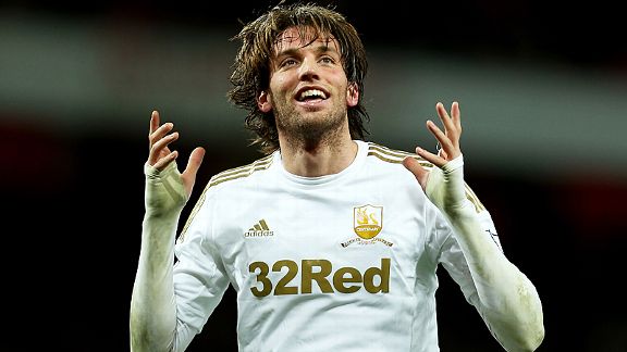 Double-goal hero Michu celebrates against Arsenal
