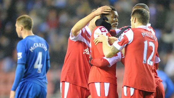 Djibril Cisse celebrates after putting QPR into a 2-1 lead at Wigan