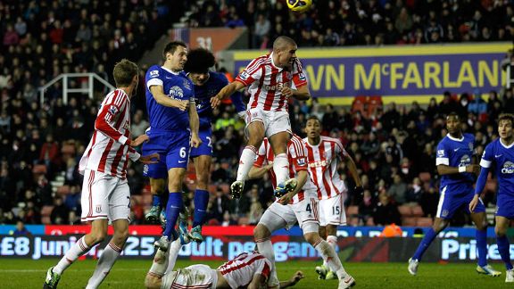 Ryan Shawcross is floored by Everton midfielder Marouane Fellaini 