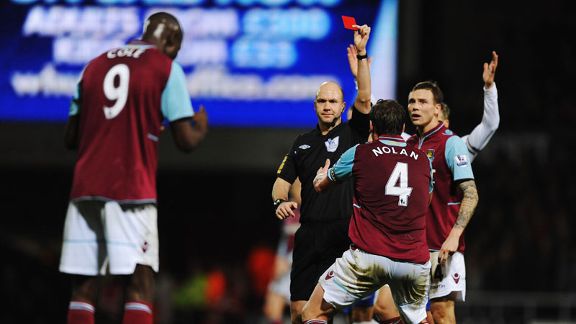 Referee Anthony Taylor shows West Ham striker Carlton Cole a red card