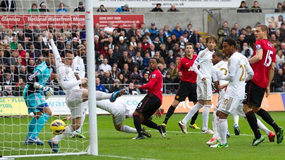 Patrice Evra heads home to give Manchester United the lead at Swansea