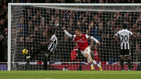 Lukas Podolski celebrates after putting Arsenal 3-2 ahead with a close-range finish