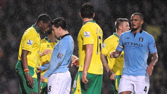 Samir Nasri squares up to Sebastien Bassong before receiving a red card