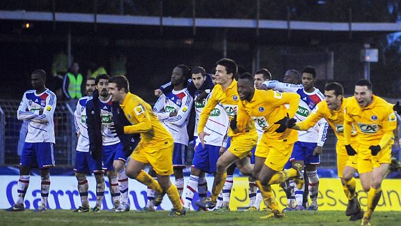 The celebrations begin for Epinal as Lyon's players can only look on in horror