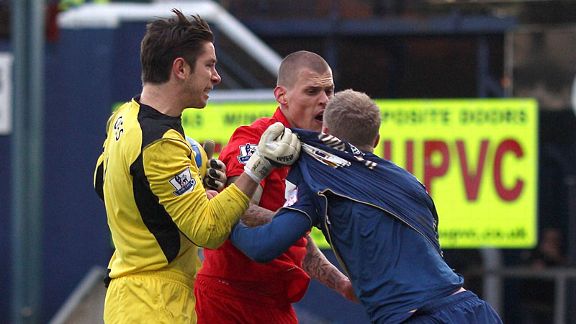 Tempers flare as Liverpool's Martin Skrtel confronts Oldham's Robbie Simpson after a late challenge on Brad Jones