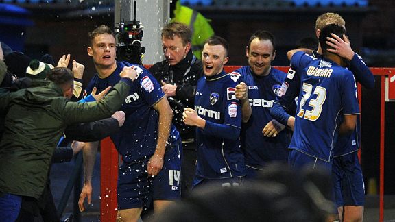 Matt Smith celebrates with his team-mates after putting Oldham into a 2-1 lead