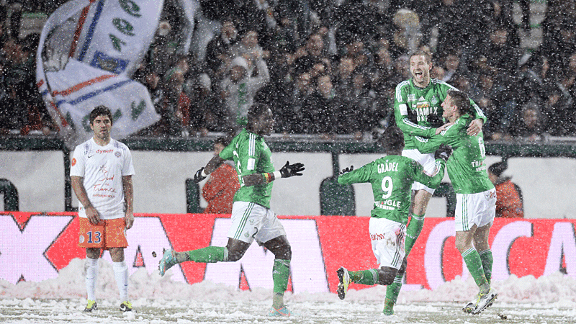 St Etienne celebrate in the snow after Mathieu Bodmer scored in their 4-1 win over Montpellier