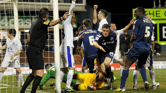 Matt Smith (c) wheels away after scoring Oldham's late equaliser