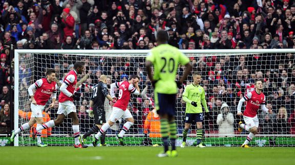 Santi Cazorla wheels away following his goal against Aston Villa