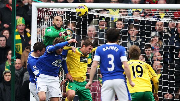 Tim Howard punches clear from Grant Holt - but the Norwich striker had the last laugh with an injury-time winner at Carrow Road.