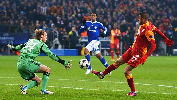 Burak Yilmaz lifts the ball over Timo Hildebrand for Galatasaray's second goal at Schalke