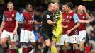 Lee Mason rejects the protestations of the Aston Villa players after awarding Chelsea a penalty