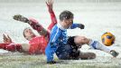 Estonia's Raio Piiroja, right, and Serbia's Branislav Ivanovic struggle for the ball in the snow as the teams draw 1-1.
