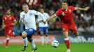 Wales' Darcy Blake and England's Wayne Rooney battle for the ball