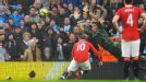 Wayne Rooney stoops to score number three despite Costel Pantilimon saving his penalty.