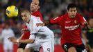 Real Madrid's Karim Benzema duels for the ball with Mallorca's Pablo Caceres 
