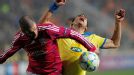 Savvas Poursaitides of Apoel Nicosia fights for the ball with Lisandro of Lyon