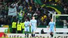 Man City players trudge back to the centre circle as Sporting players celebrate Xandao's goal.