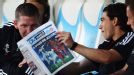 Bastian Schweinsteiger engages in some reading on the bench ahead of Bayern Munich's game at Marseille