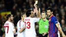 Alessandro Nesta gets a yellow card after tugging back Sergio Busquets for Barcelona's second penalty.