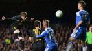 Lionel Messi leaps to head the ball on goal but can't find the net
