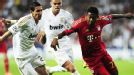 Angel di Maria and David Alaba battle for the ball.