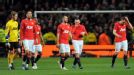 Manchester United players trudge off disconsolately after defeat