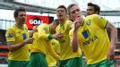 Norwich celebrate after Steve Morison (R) scored to give them a point at Arsenal