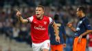 Lukas Podolski celebrates after putting Arsenal level at Montpellier