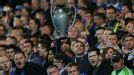 A Chelsea fan celebrates with an inflatable Champions League trophy for the Blues' first match in defence of their trophy