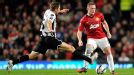 Manchester United's Wayne Rooney, right, is tackled by Newcastle's United's Dan Gosling
