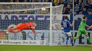 Schalke goalkeeper Lars Unnerstall saves a shot from Wolfsburg's Emanuel Pogatetz