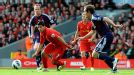 Luis Suarez of Liverpool bursts through the Stoke players