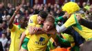 Norwich celebrate after Michael Turner put them back on level terms at Villa Park