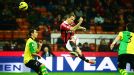 Milan's Philippe Mexes acrobatically clears his lines against Chievo