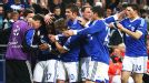 Jefferson Farfan is mobbed after scoring the goal which earned Schalke a 2-2 draw with Arsenal