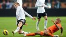 Lewis Holtby is tackled by Nigel de Jong in Germany's friendly with Netherlands