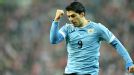 Luis Suarez celebrates after scoring Uruguay's final goal in a 3-1 win over Poland