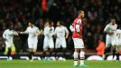 Theo Walcott is a lonely figure as Swansea celebrate one of Michu's two goals
